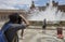 Young tourist taking picture to bubble cloud at Plaza de EspaÃ±a fountain, Seville