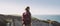 Young tourist woman with backpack looking at sea in Normandy, France over beautiful cliffs background