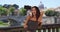 Young tourist woman on bridge in Rome taking selfies near St. Peter\'s Basilica