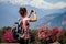 A young tourist woman with a camp backpack photographing landscapes and making selfi in the Himalaya Mountains. trekking