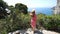 Young tourist woman descends stairs towards a terrace in the Gardens of Augustus on Capri Island, Italy