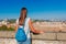 Young tourist woman and landscape of beautiful Roma from the Aventine hill with a clear blue sky and sunny day. Famous tourist