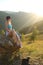 Young tourist woman is sitting on the top of the mounting and lo