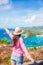 Young tourist woman with view of English Harbor from Shirley Heights, Antigua, paradise bay at tropical island in the