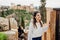 Young tourist woman visiting Granada,Andalucia,Spain.Smiling woman sightseeing old historic landmarks with Alhambra in the