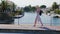 Young tourist woman walking on the bridge over the canal. The area Empuriabrava, Spain. Use smartphones. Concept -