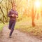 Young trail runner man jogging in the morning park