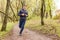 Young trail runner man jogging in the morning park