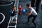 Young trainer teaches kids boxing sport in the gym