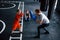 Young trainer teaches kids boxing sport in the gym