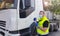 A young transporter on the truck with face mask and protective gloves for Coronavirus