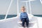 Young traveler. Child cute sailor yacht sunny day. Boy adorable sailor striped shirt white yacht travel around world