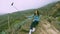 Young traveler girl making photos with fascinating view of volcanic rocks