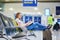 Young traveler in international airport reading a book while waiting for her flight