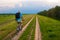 Young traveler riding bicycle on country road