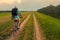 Young traveler riding bicycle in summer