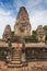 Young traveler wearing a hat with backpack and tripod - at Angkor Wat