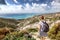 A young traveler woman with a backpack on a stunning landscape b