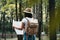 Young traveler woman hold location map in hands among trees in forest and searching directional for traveling