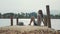 Young traveler woman sits on the wood pier and enjoy nature in slow motion