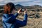 Young traveler woman taking photo of scenic volcanic landscapes