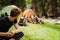 Young travelers resting in tents while hiking in green forest