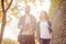 Young travelers walking in autumn park. Man and woman having vacation. Backpackers, traveling and tourism.