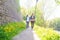 Young travelers walking in a park. Man and woman having vacation. Backpackers, traveling and tourism.