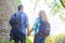 Young travelers walking in a park. Man and woman having vacation. Backpackers, traveling and tourism.