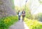 Young travelers walking in a park. Man and woman having vacation. Backpackers, traveling and tourism.