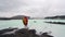 Young traveling man standing and looking blue lagoon in Iceland.