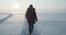 Young traveller goes through a blizzard at beautiful sunset. Polar expedition