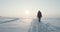 Young traveller goes through a blizzard at beautiful sunset. Polar expedition