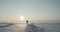 Young traveller goes through a blizzard at beautiful sunset. Polar expedition