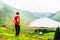 A young traveller man observing a lake in a deep valley covered