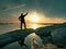 Young traveller standing on stone and watching at sun