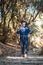 Young traveller trekking on forest trail , Nepal