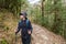 Young traveller trekking on forest trail , Nepal