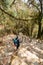 Young traveller trekking on forest trail , Nepal