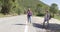 Young travellers hitch hiking on road