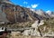 Young trekker girl standing on the bridge over the river. Annapurna Circuit Trek, Nepal.