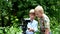 Young two boys with video camera shoots film about nature of green park.