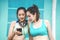 Young two sports women friends in sports clothes are sitting on bench, relax after sports training