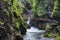 Young undefined girl walking on wooden bridge  at Vintgar Gorge canyon