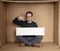 Young unemployed man holding a white board, a place for advertising, the idea of a cry for help