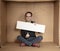 Young unemployed man holding a white board, a place for advertising, the idea of a cry for help