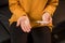 Young unhealthy woman sits on a sofa in the living room at home with pills and a thermometer in her hands