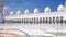 Young unknown local muslim woman in traditional black dress and hijab  crossing inner court of Sheikh Zayed Mosque.