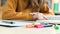 Young unrecognisable female college student in class, reading textbook. Focused student in classroom.