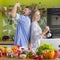 Young unrecognizable couple preparing healthy lunch and funny singing